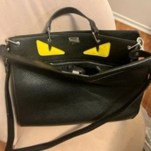 Black leather bag with yellow eyes - good for a laptop